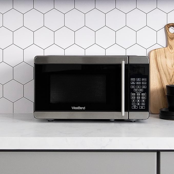 West Bend Microwave Oven 700-Watts Countertop Compact Footprint with 6 Pre Cooking Settings, Speed Defrost, Electronic Control Panel and Glass Turntable Perfect for Small Spaces, 0.7-Cu.Ft., Metallic